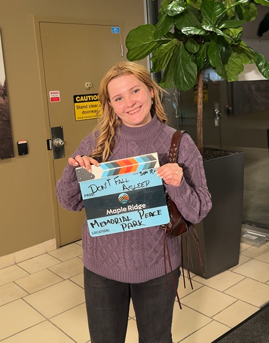 Actress Abigail Breslin holding a City-branded film slate in the Maple Ridge Business Centre.